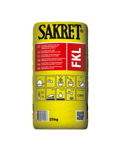 SAKRET FKE gray tile adhesive being applied for floor tiling with underfloor heating and stone facade panels.